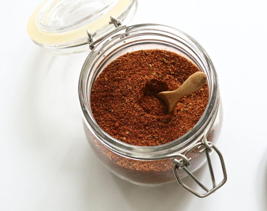 close up of seasoning mix in a glass jar