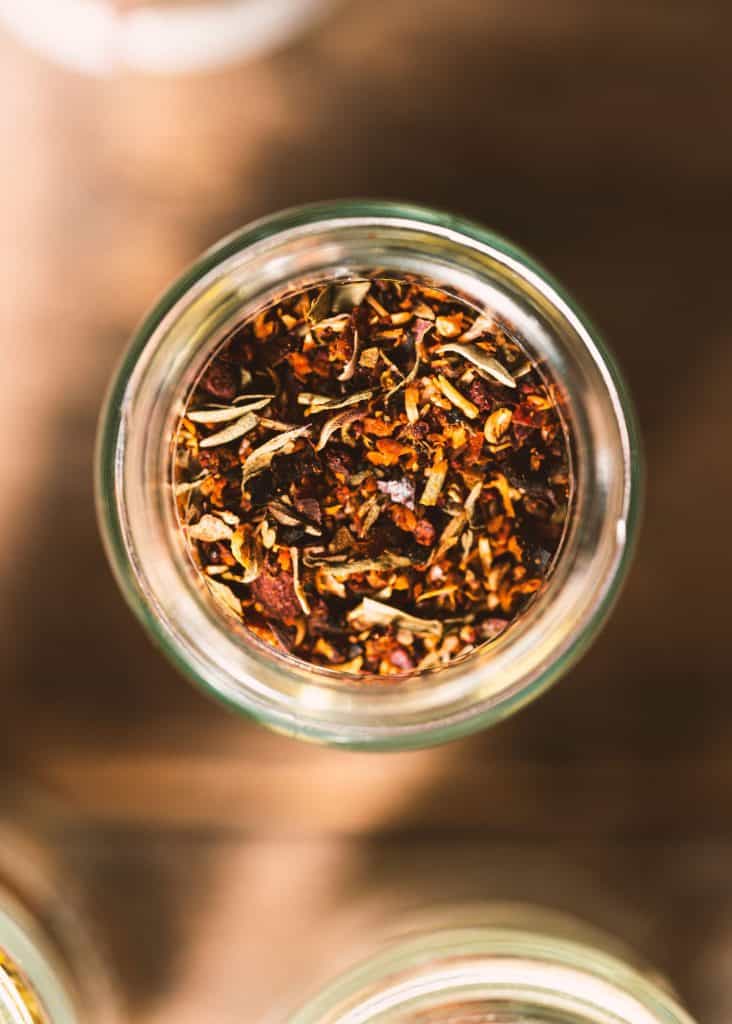 close up of seasoning mix in a glass jar