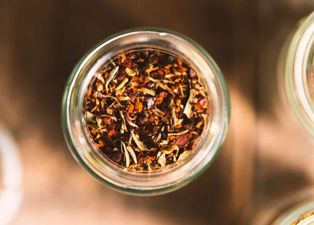 close up of seasoning mix in a glass jar