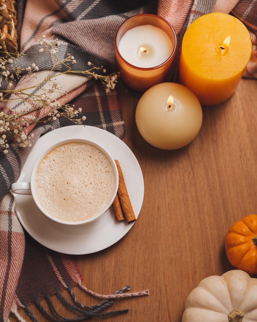 cinnamon latte on a cup with pumpkins