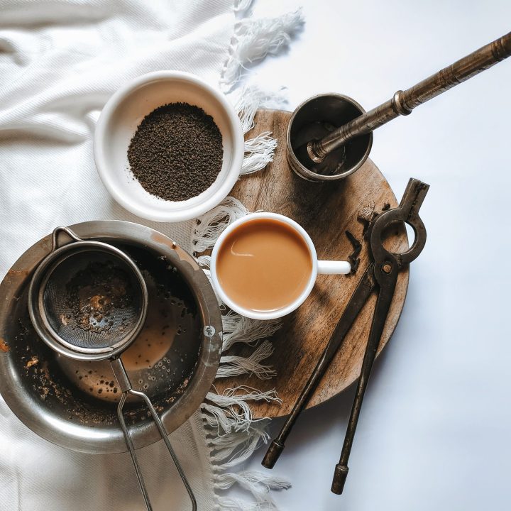 chai tea with herbs and strainer