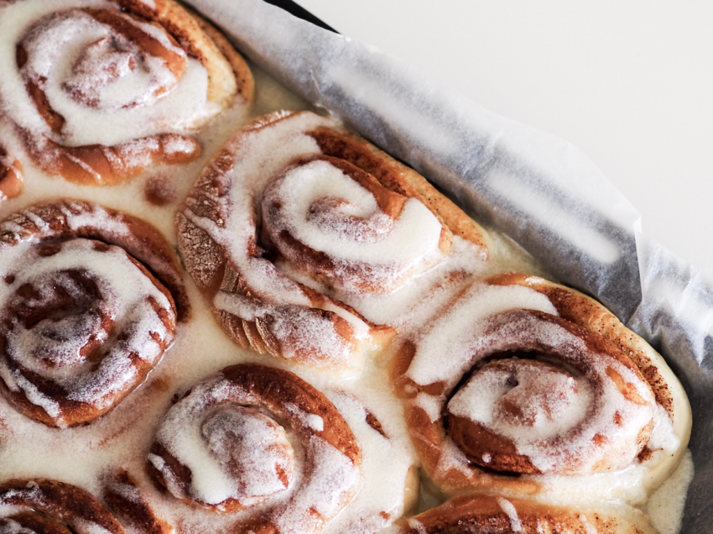 homemade cinnamon rolls in a pan with icing