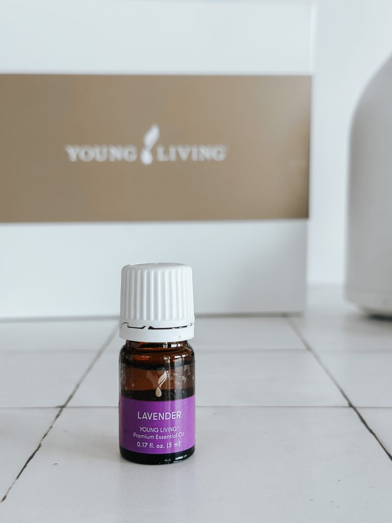 bottle of lavender essential oil on a white counter