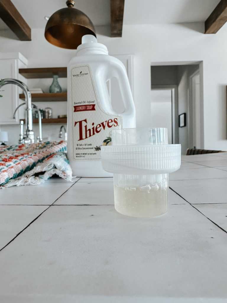 Close up of laundry soap cap with bottle in background