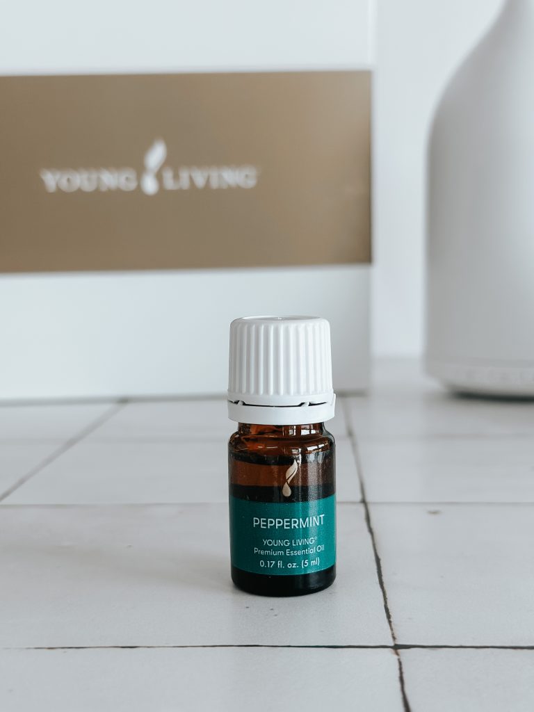 bottle of peppermint essential oil on a white counter