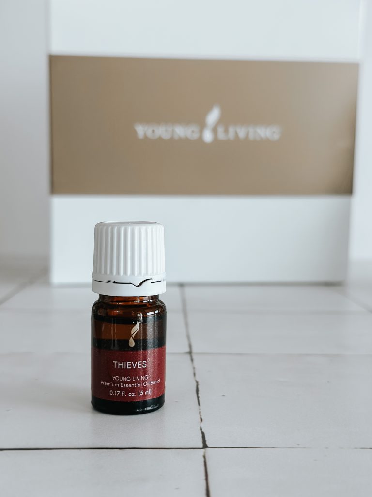 bottle of thieves essential oil blend on white counter