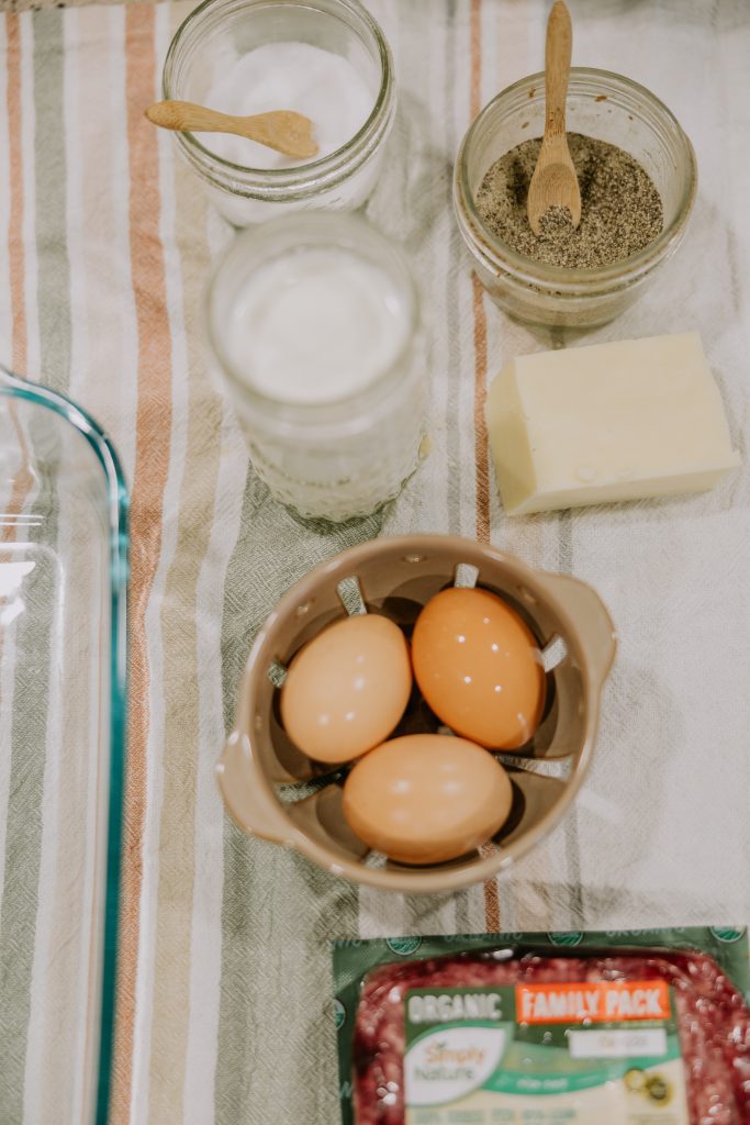 Close up of ingredients for breakfast casserole - eegs, ground beef, milk, cheese