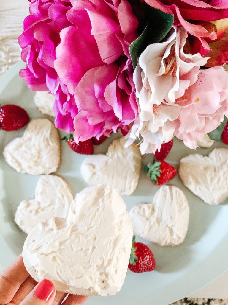 Close up of a heart-shaped sugar cookie with white icing