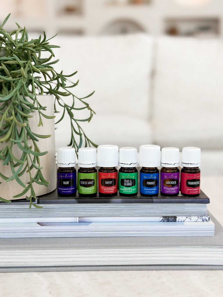 7 essential oil bottles sitting on a book