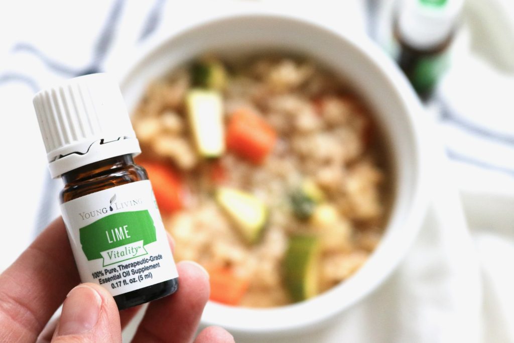 An image of Young Living Lime Vitality Essential Oil above a bowl of chicken tortilla soup.