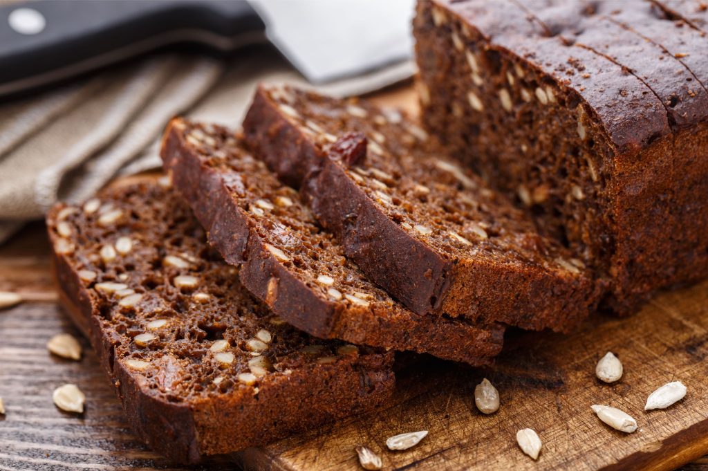 horizontal images of sliced pumpkin bread on a wooden cutting board