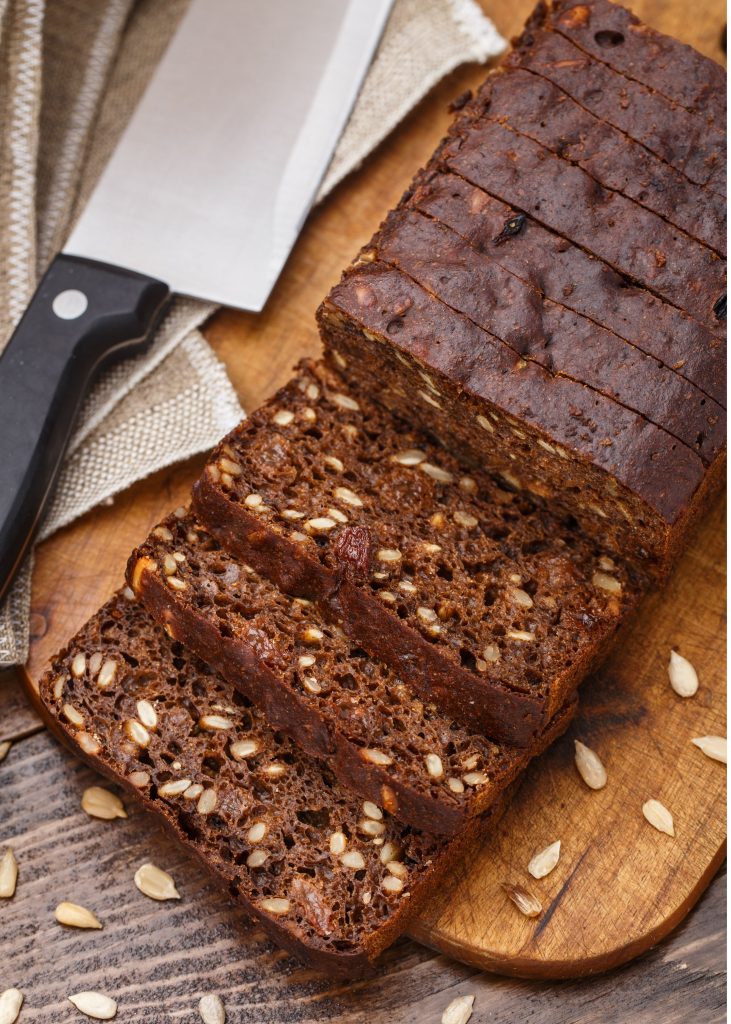 sliced pumpkin bread on a wooden cutting board