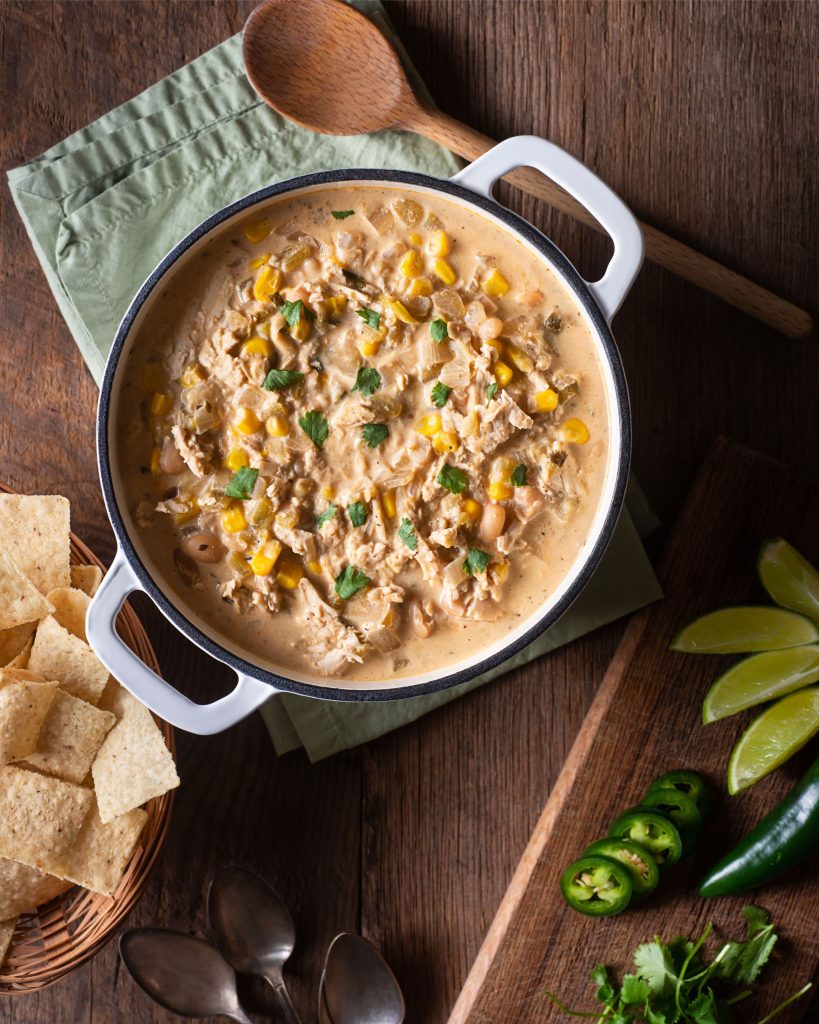 white chili in a large pot on a wooden table