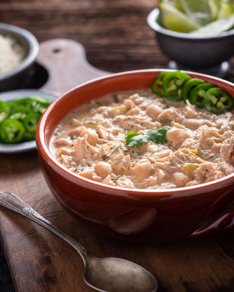 Close up of white chili in a red bowl