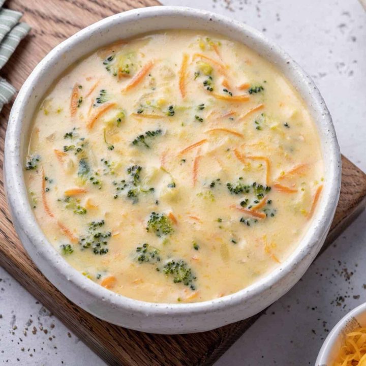 broccoli cheese soup on wooden tray with green napkin