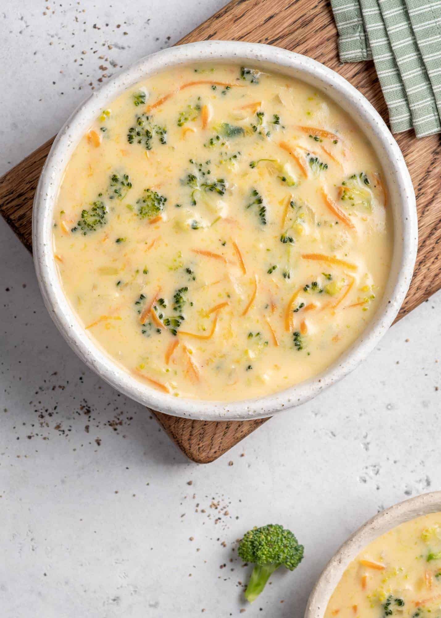 broccoli cheese soup on a wooden cutting board