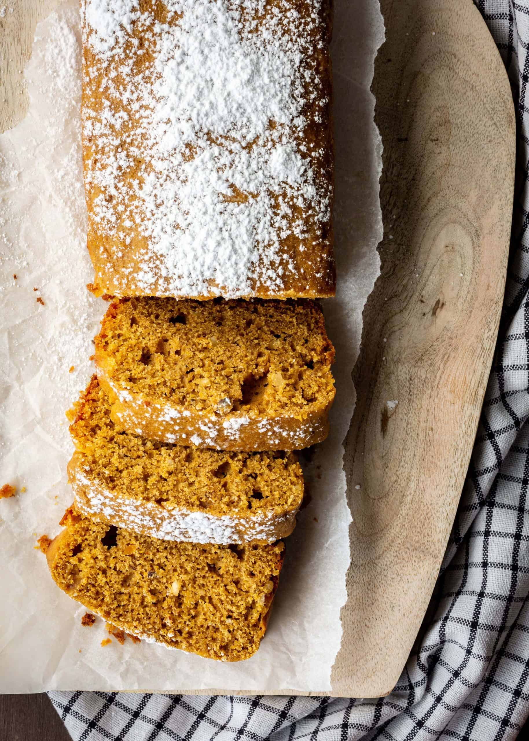 Sliced pumpkin bread with powdered sugar