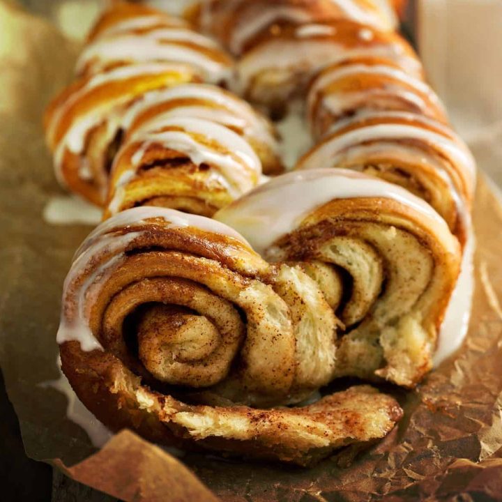 Close up of an iced loaf of cinnamon pull-apart bread, warm and fresh from the oven, waiting to be shared!