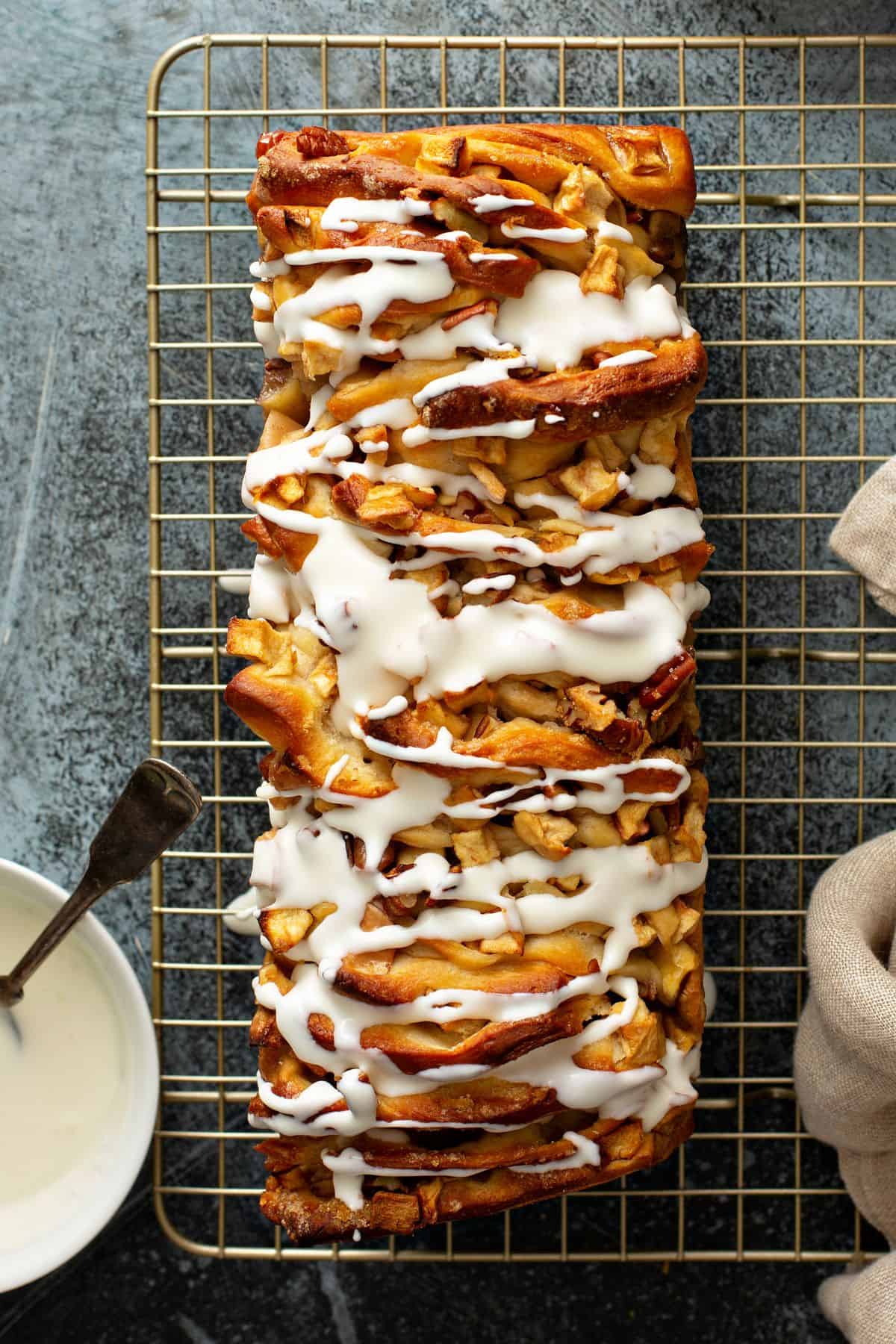 Nut and apple pull apart bread, iced on a cooling rack - a delicious variation of cinnamon pull-apart bread! 