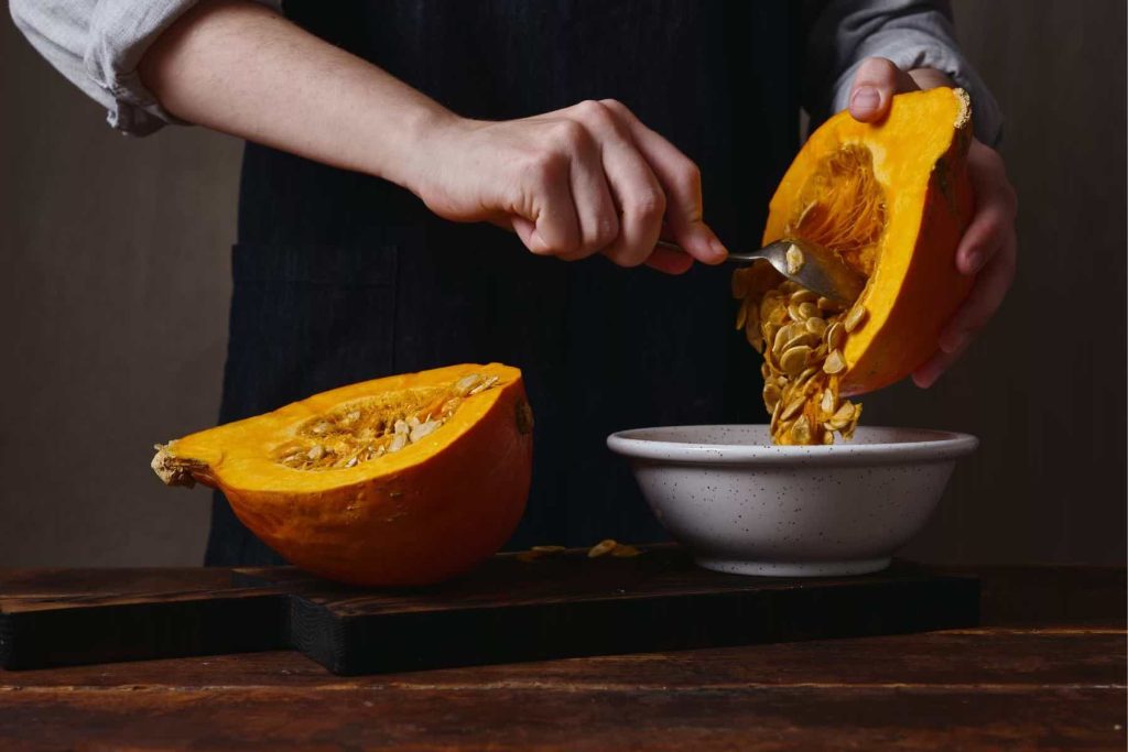 Collage of removing seeds from a fresh pumpkin, pureeing the bakes pumpkin, then mixing into ingredients for a pumpkin pie.