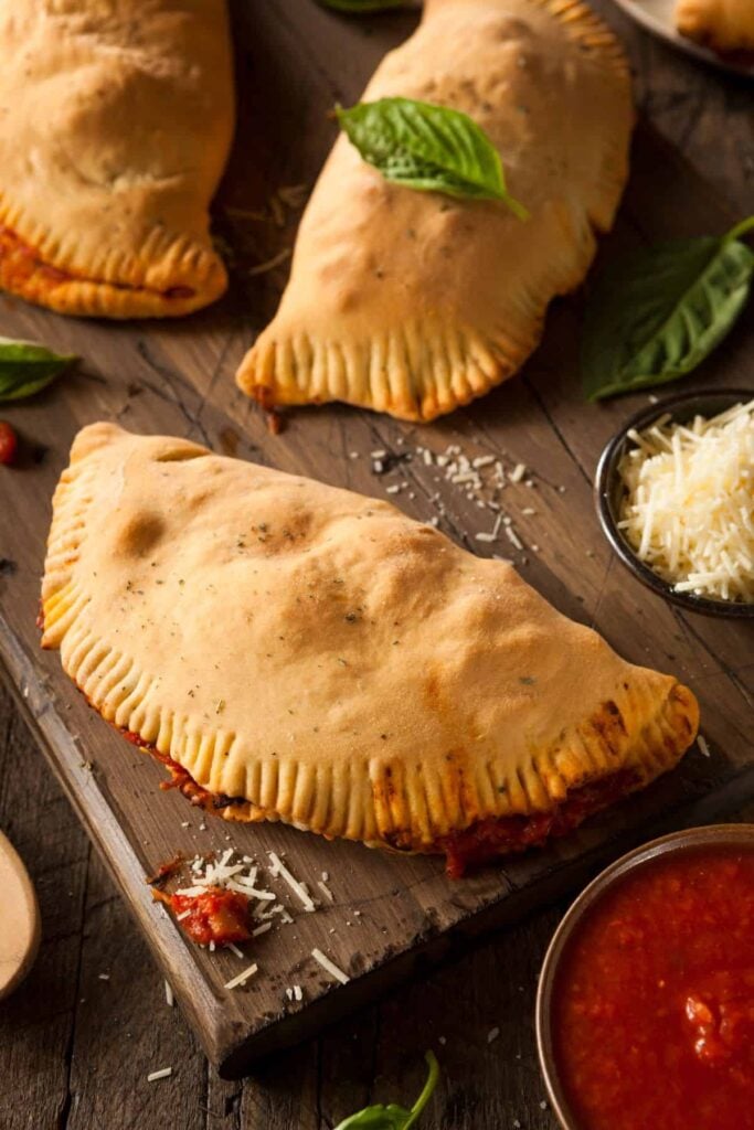 Sourdough calzones on a cutting board ready to be devoured.
