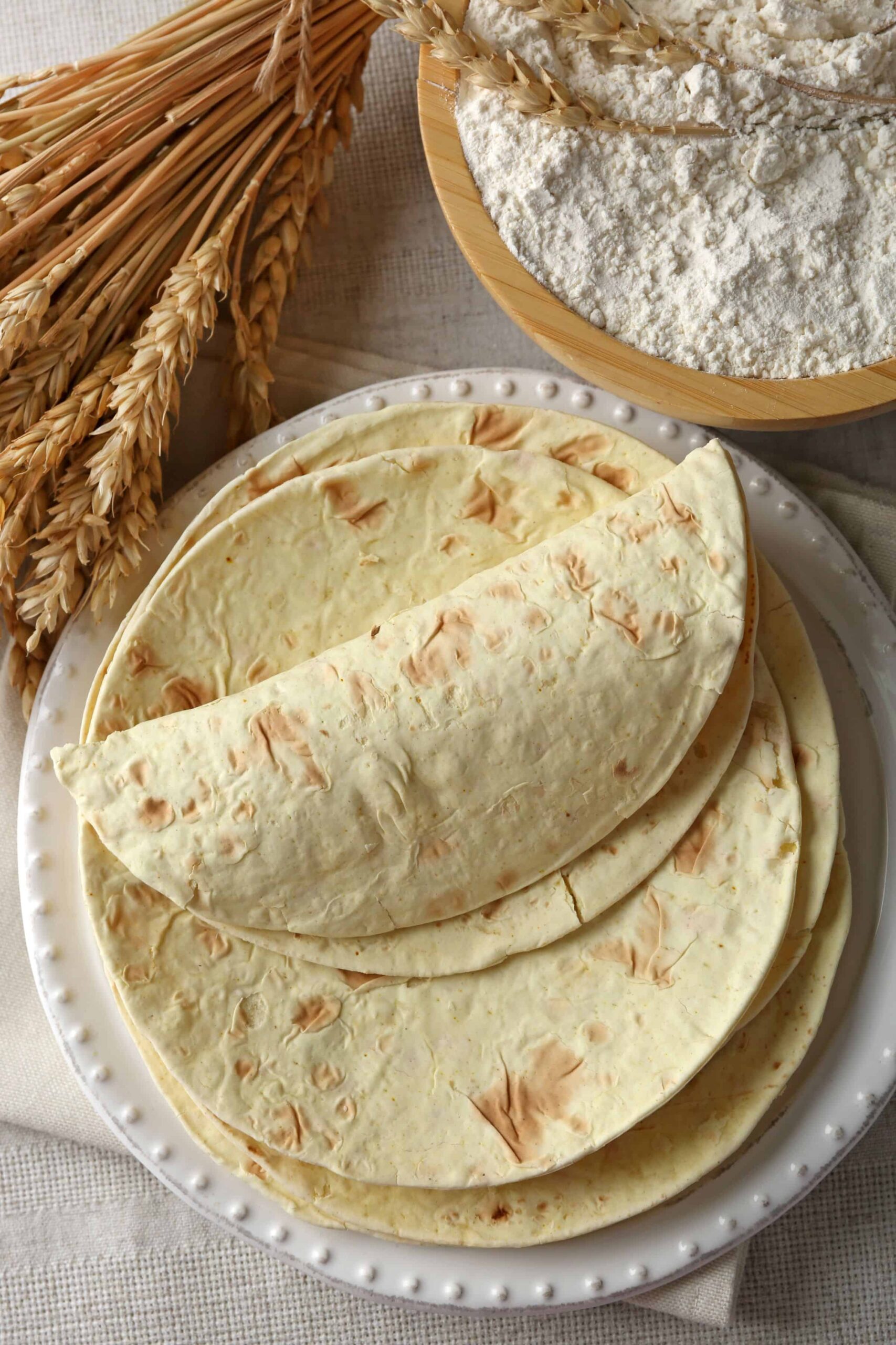 Whole grain tortillas on a white plate