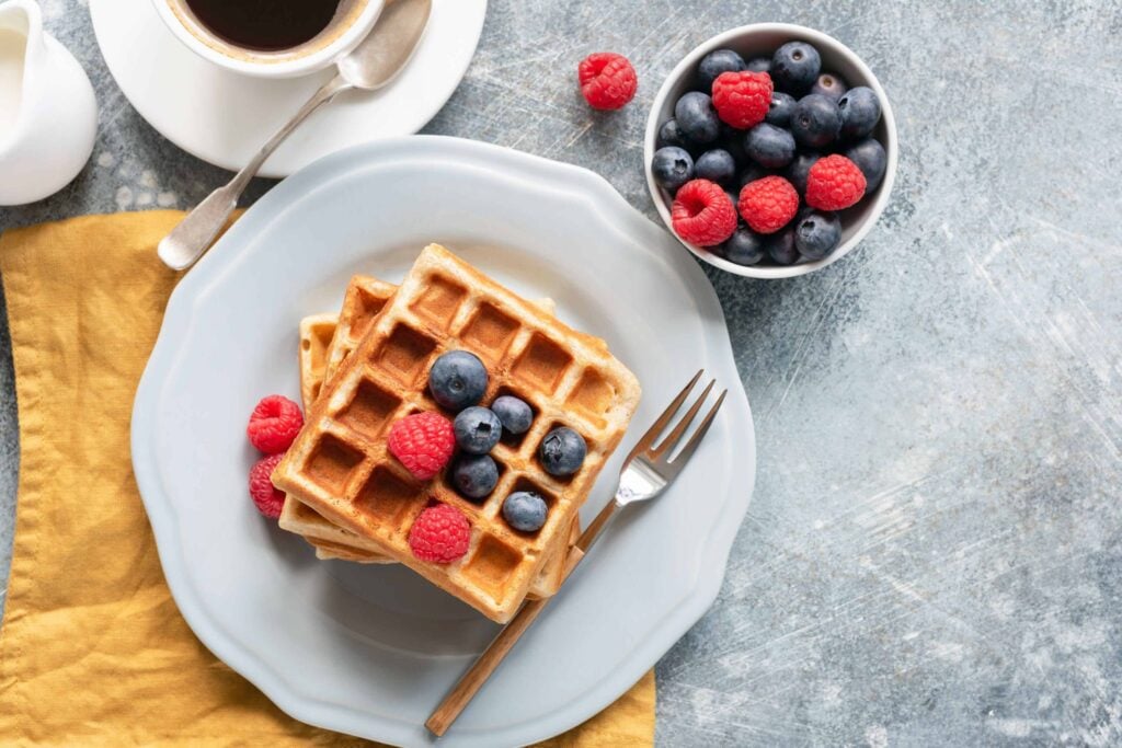 Close up of fresh milled flour Belgian waffles with fresh berries ready to eat.