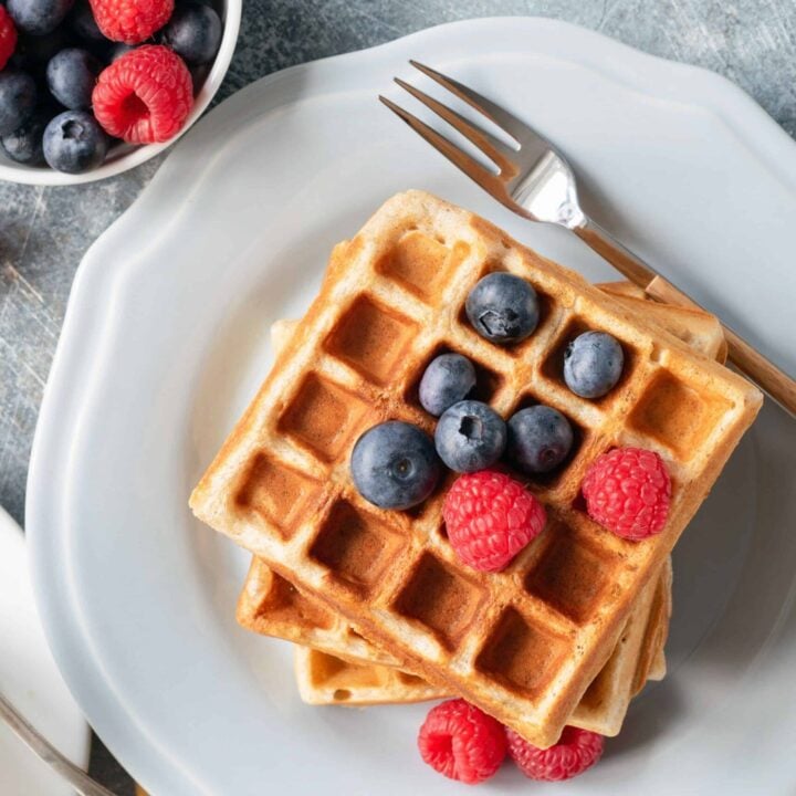 fresh milled whole wheat waffle stack with blueberries and raspberries