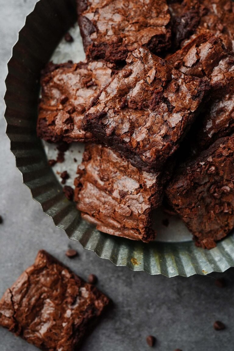 chocolatey, fresh milled flour brownies on a metal cake plate