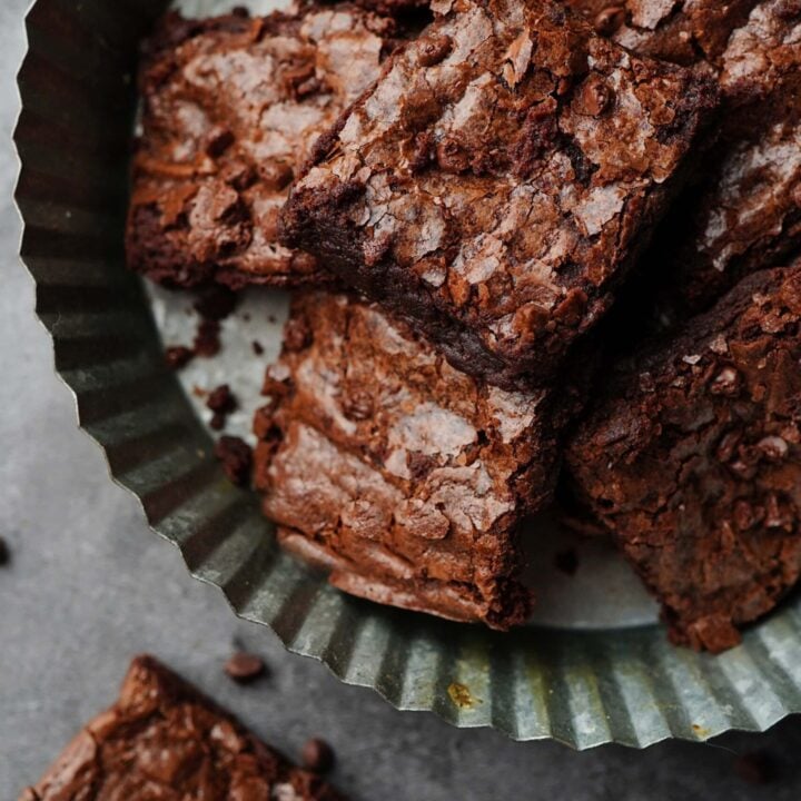 chocolatey, fresh milled flour brownies on a metal cake plate