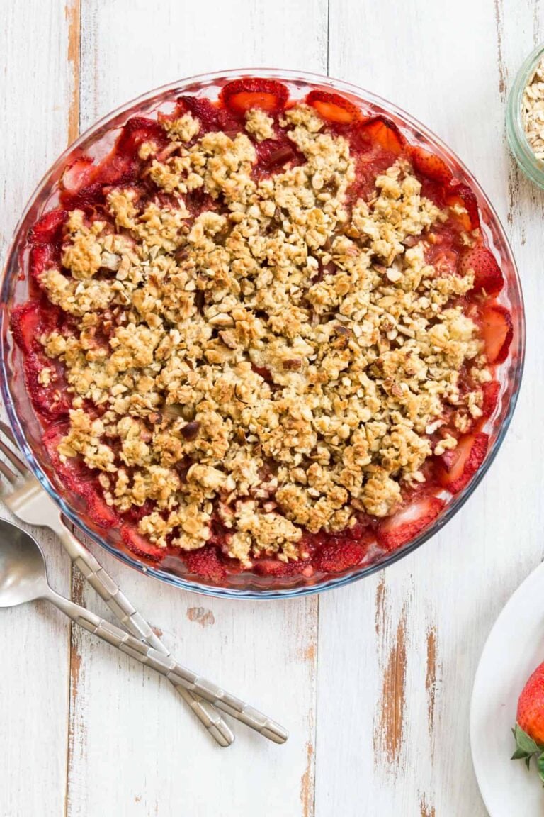 Rhubarb and strawberry crunch on a white table.