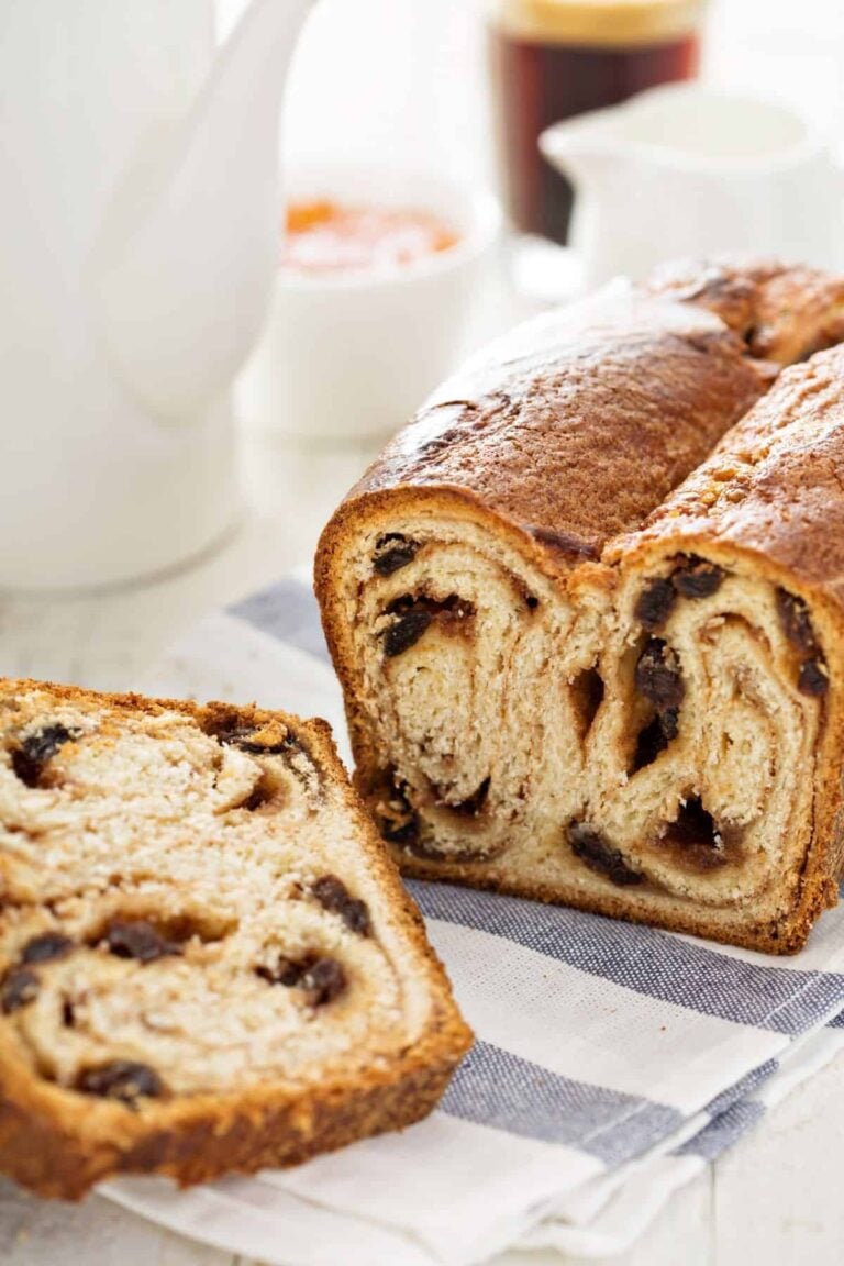 Whole wheat cinnamon raisin bread sliced on a tea towel