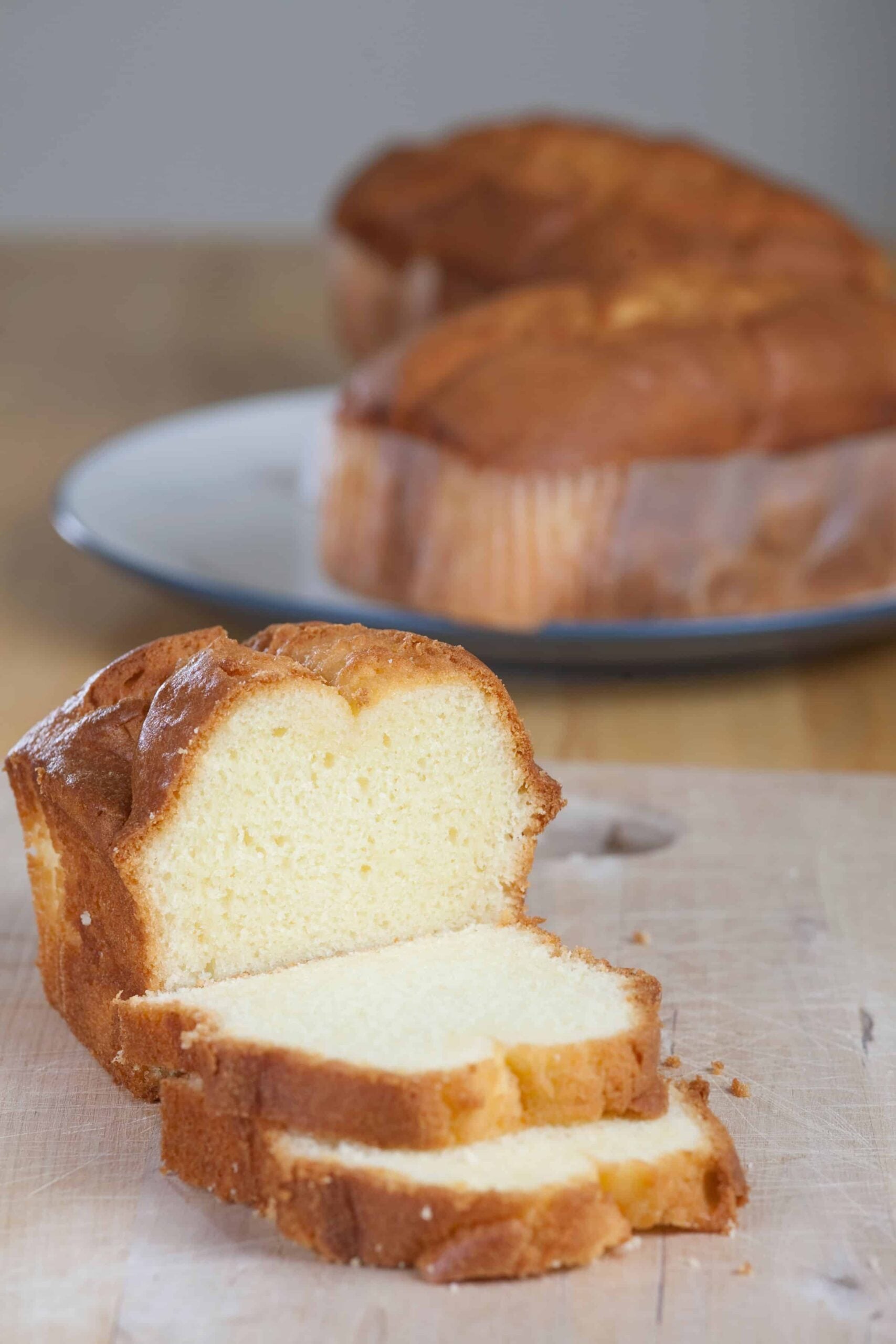 Close up of fresh milled flour pound cake sliced on a wooden cutting board
