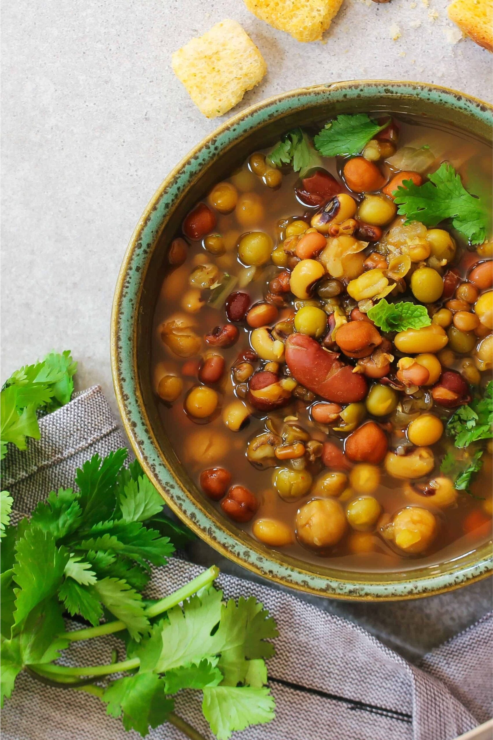 Close up of a healthy 7 bean soup recipe with fresh herbs