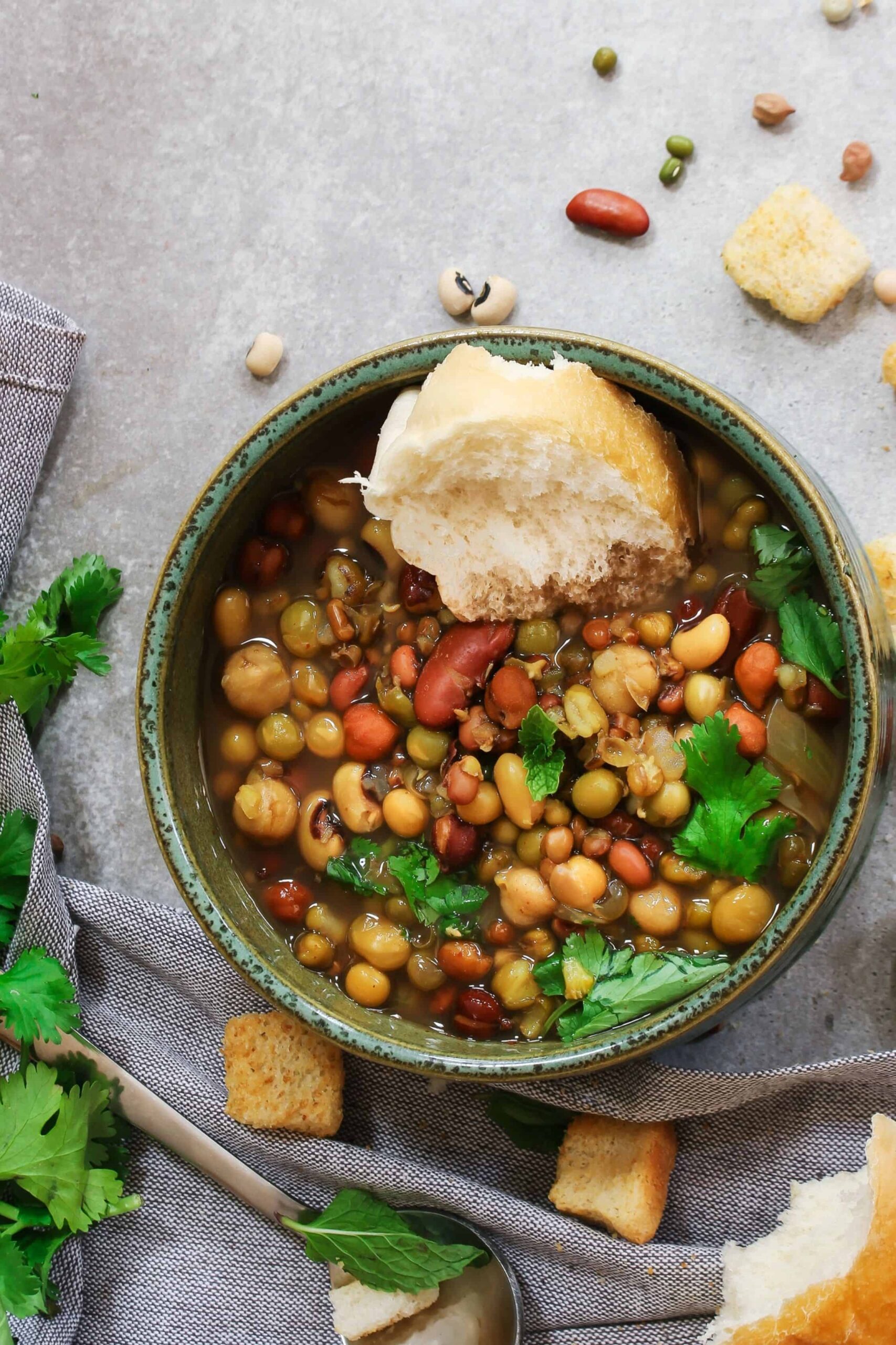 Delicious 7 beans soup with fresh bread, croutons, and fresh herbs.