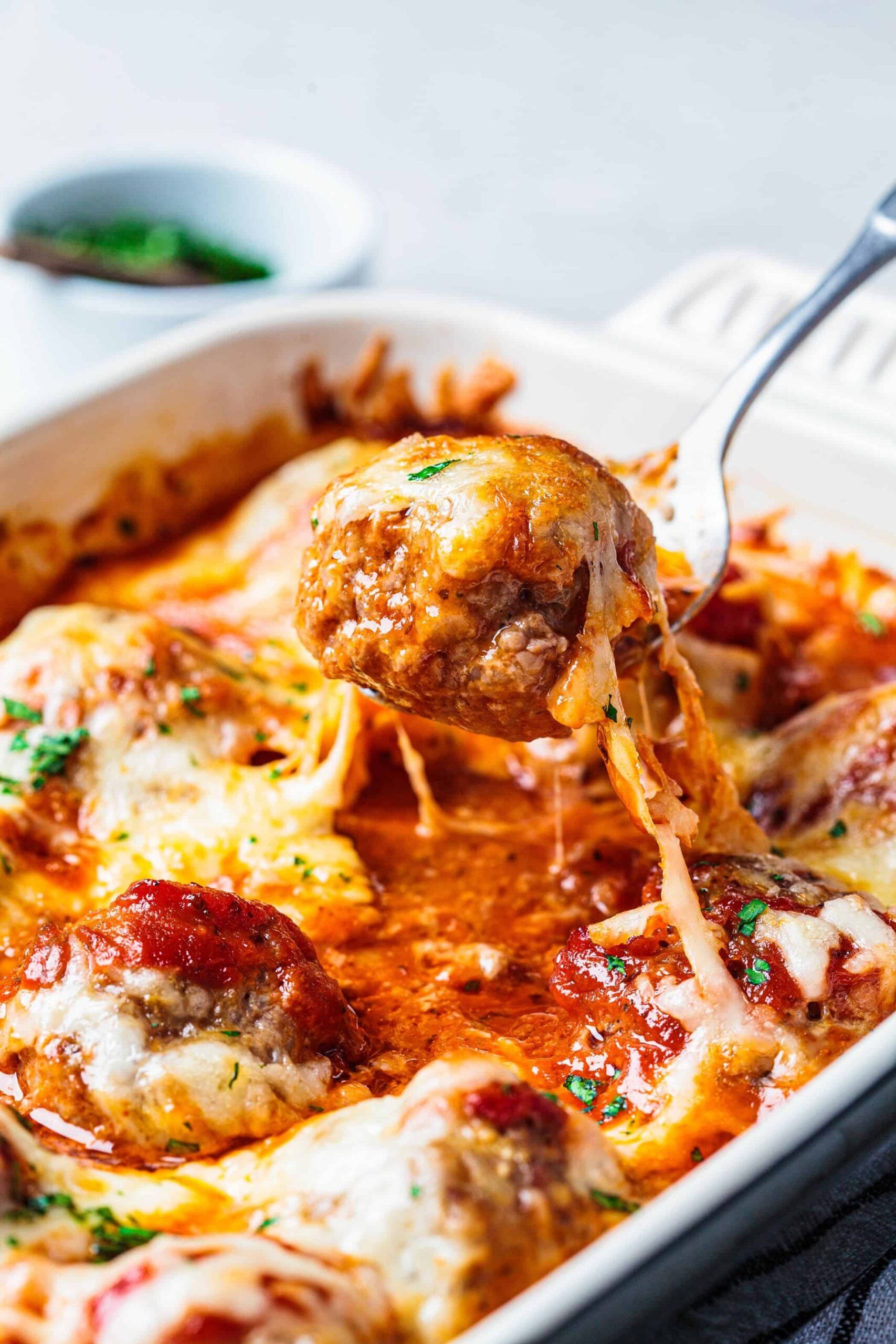 Cheesy meatball casserole being served