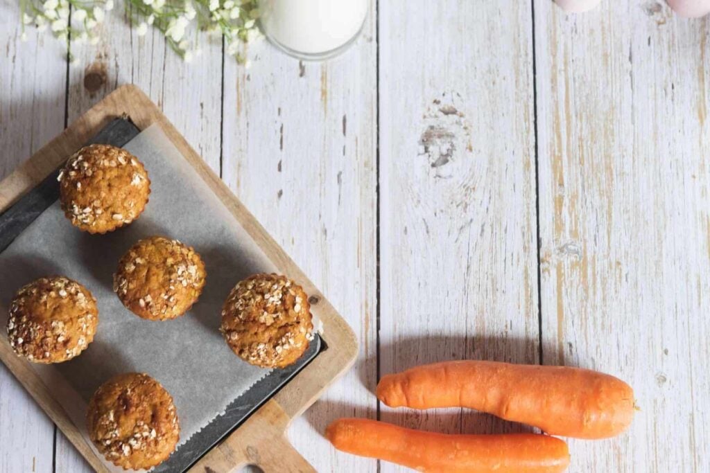 Whole wheat carrot zucchini muffins on a tray.