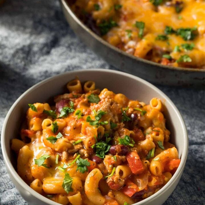 Bowl of cheesy turkey taco chili mac on a tea towel